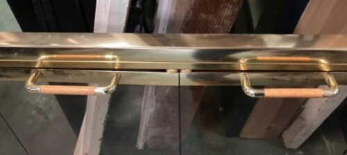 Detail of brass and smoked glass fire screen with wooden handles and double bifold doors, 1140mm wide x 730mm high (F09) $225