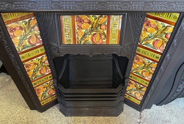 Original Victorian fireplace insert, fully restored cast iron. Late 1800s, unusual fine casting with original summer dress cover. Completed with stunning, rare hand painted feature tiles with pomegranates and foliage. Rich colours, and strong brushwork on the bold Aesthetic Period design. Possibly by Craven Dunnill / Godwin & Hewitt, UK. Selling as a complete set with the fireplace and original cast iron dress cover. H 965 x W 965mm - Image 2
